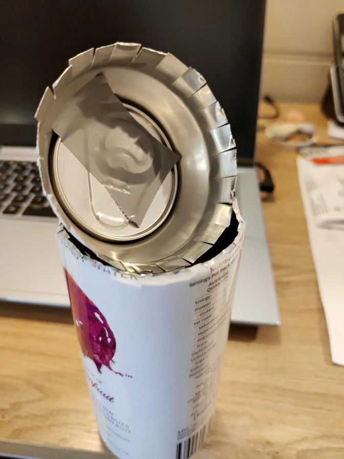 A coconut water can, with the top cut out, and some flaps to easily fit the top again